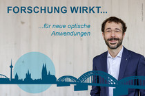 Prof. Gather with an illustration of the Cologne skyline